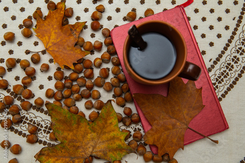 Autumn sentiment. Pictures of Autumn Coffee, Leaves, Books, Hazelnuts and Flowers. © Tudorean