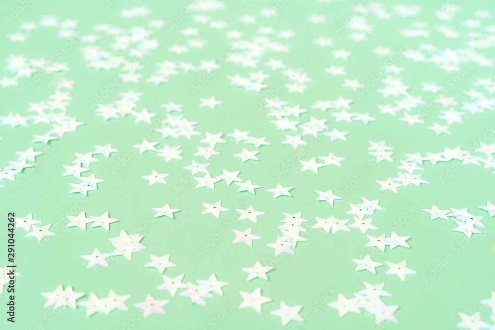 Light pink pearl stars on a mint pastel background. Holiday concept Light pink pearl stars on a mint pastel background. Holiday concept