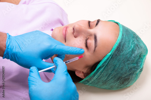 Doctor Giving Facial Skin Lifting Injection On Woman's Face