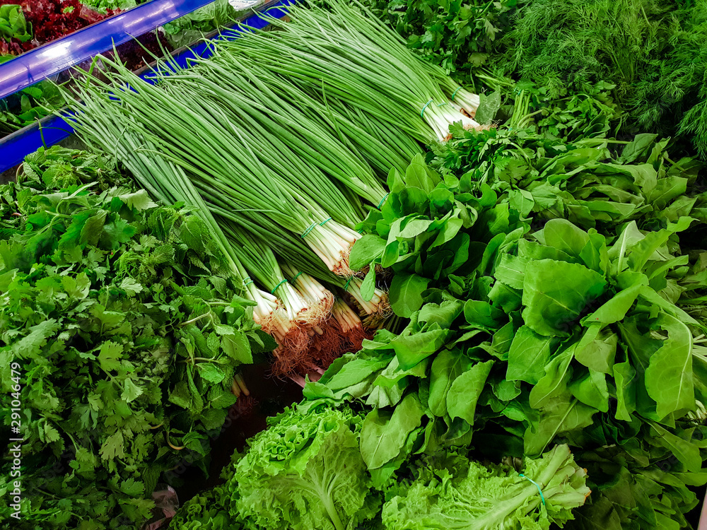 Fototapeta premium Variety of green vegetables in a supermarket. Consumption of green vegetables has increased in recent years, as more people try to follow a healthy lifestyle.