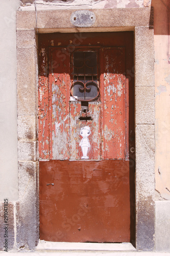 Isolated old wooden closed brown door with stain knob