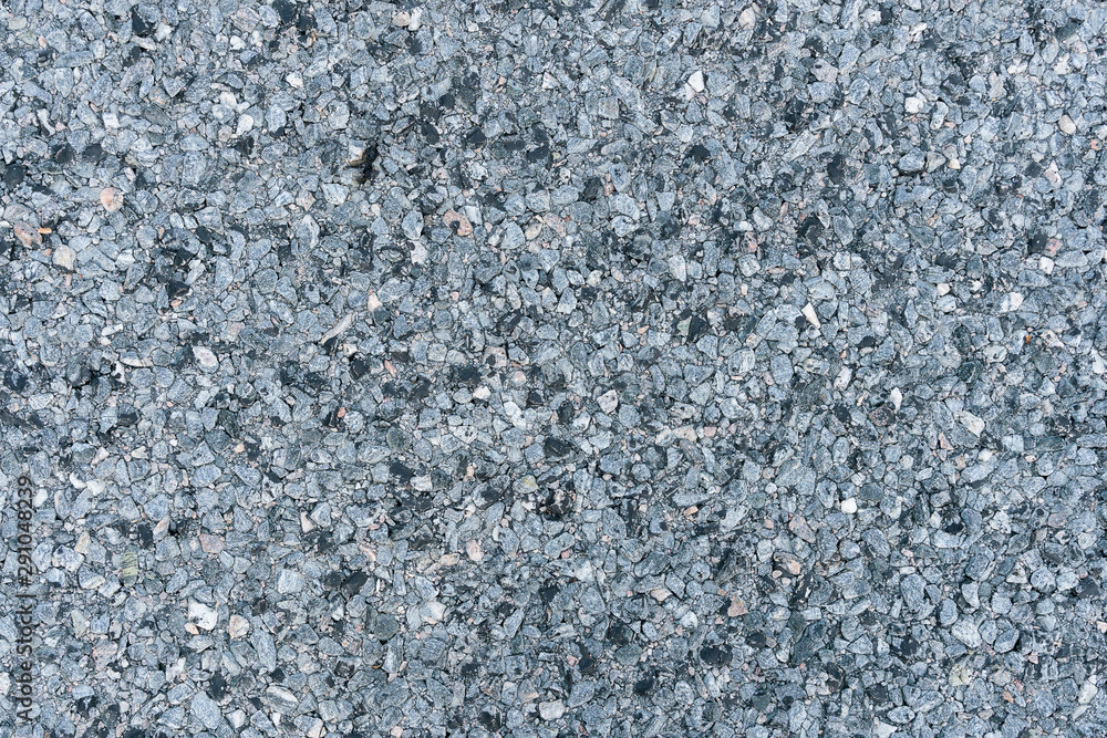 Road surface. Background from a pile of small stones of gray rubble. grey gravel floor texture background