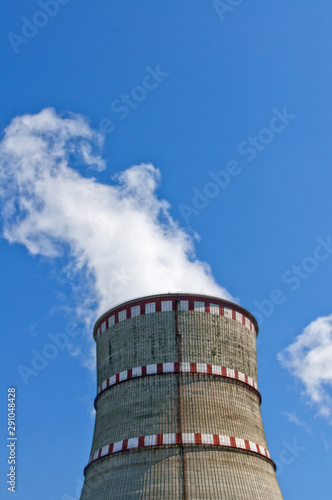 Atomic reactor. Operating nuclear power plant. Smoke from the chimney  blue sky. Power Generation