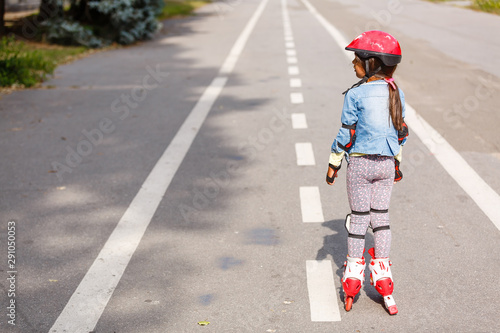 little girl rollerblading along the tracks