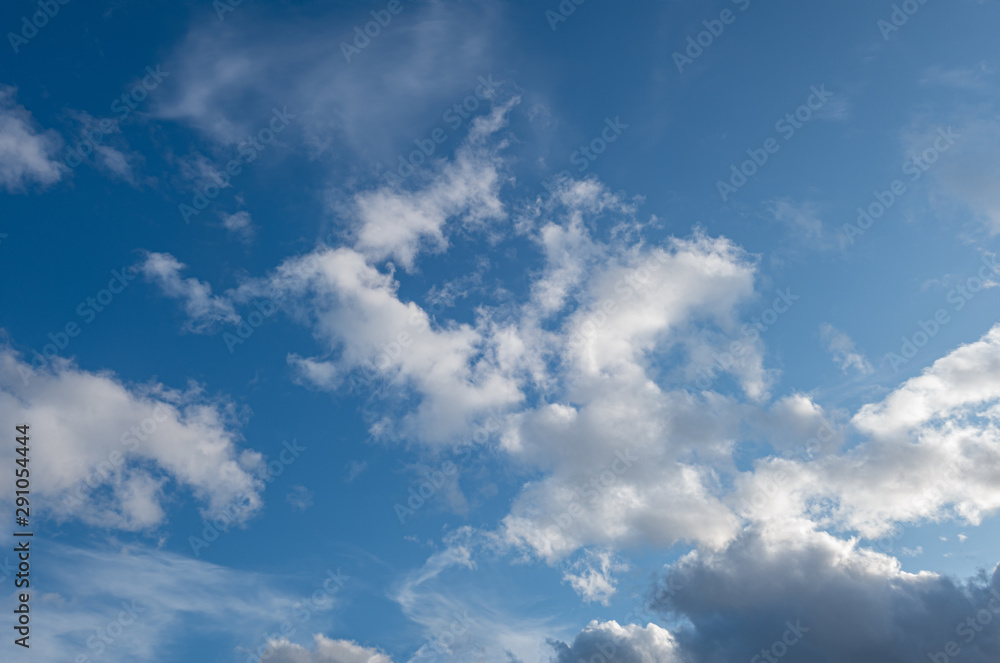 abstract background of light fluffy clouds on a bright blue sky