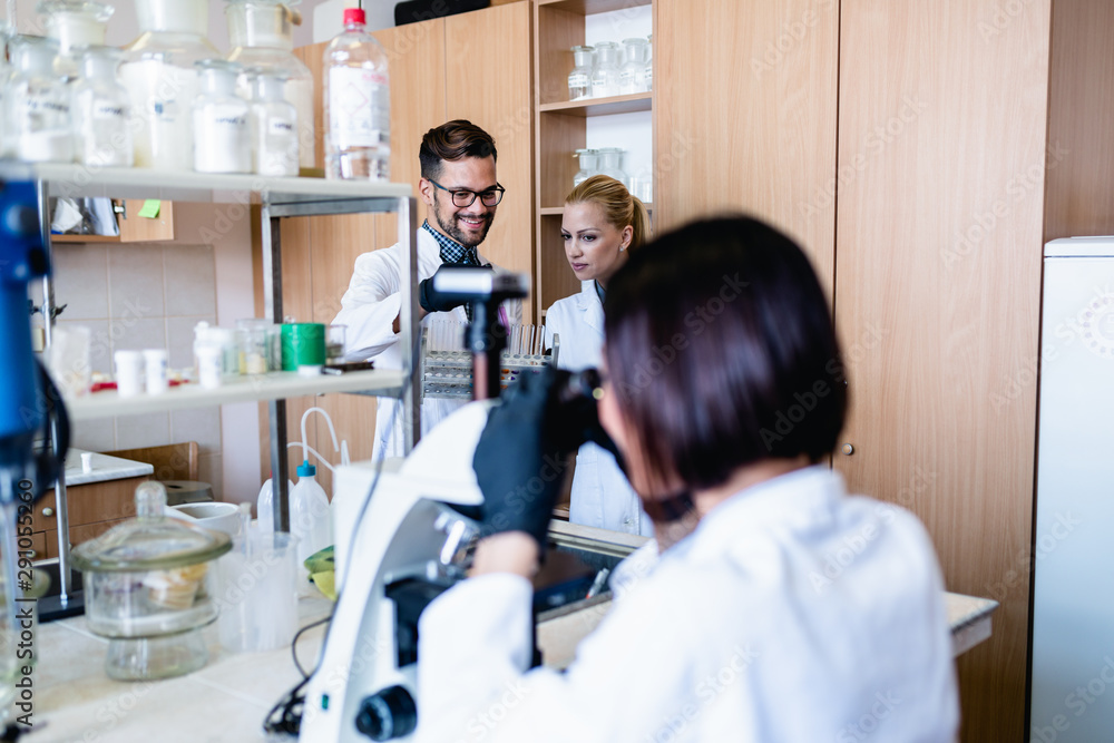 Middle age scientists and researchers work in chemical laboratory. Middle age scientists and researchers work in chemical laboratory.
