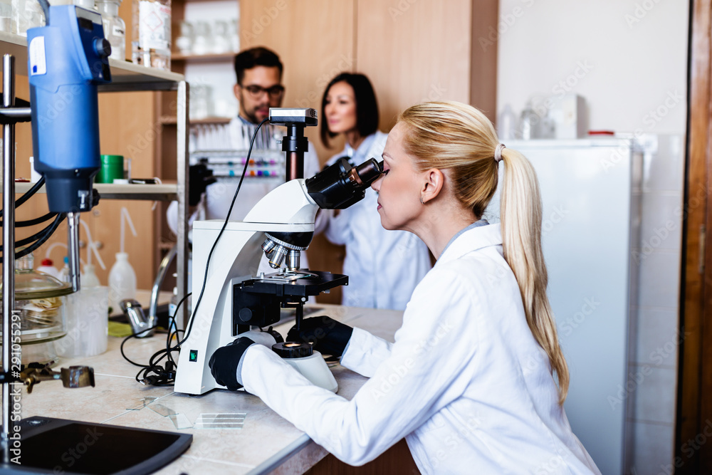 Middle age scientists and researchers work in chemical laboratory. Middle age scientists and researchers work in chemical laboratory.
