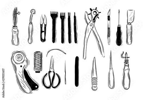Leather craft tools on a wooden background
