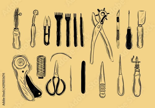 Leather craft tools on a wooden background