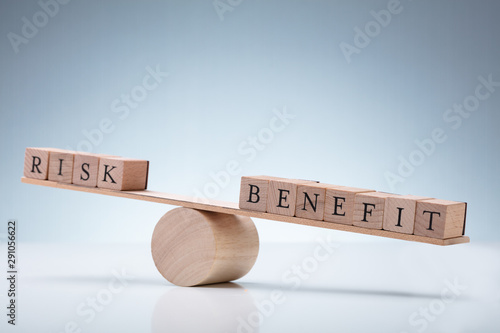 Obraz na płótnie Wooden Block With Risk And Benefit Wooden Block On Seesaw