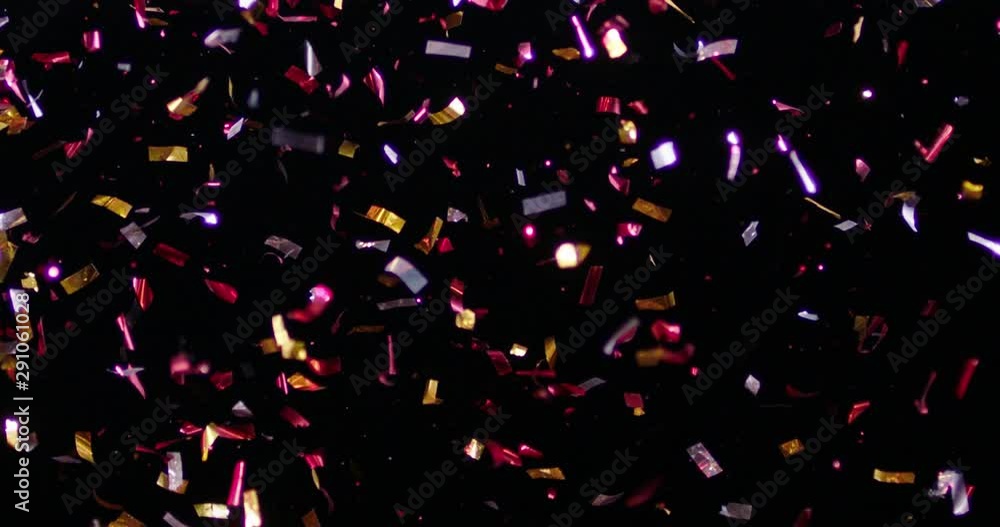 Confetti fired in the air during a party. Only confetti on black background of the night. Falling metallic glitter foil confetti multicolor in black background. Confetti fired in the air during a party. Only confetti on black background of the night. Falling metallic glitter foil confetti multicolor in black background.
