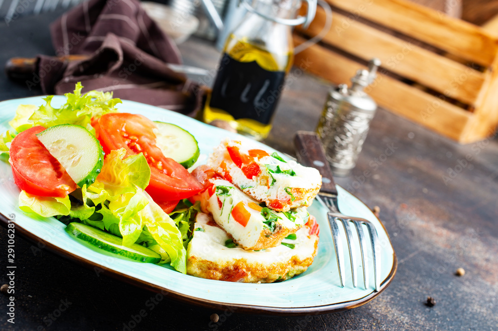 omelette with vegetables on white plate omelette with vegetables on white plate
