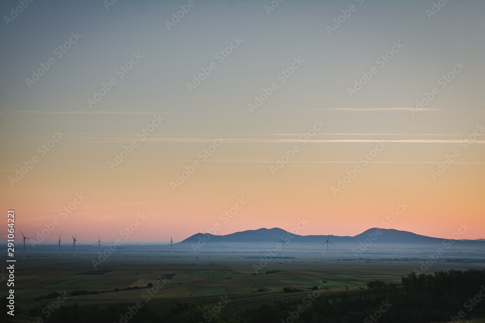 View on a distant mountains in a plain on a foggy morning