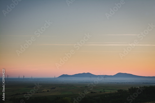 View on a distant mountains in a plain on a foggy morning