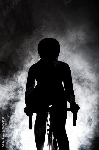 female roadbiker silhouette with smoke