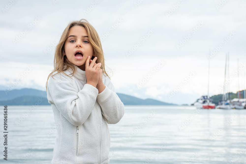 Standing child girl expresses diverse faces of surprise and curiosity. Standing child girl expresses diverse faces of surprise and curiosity.