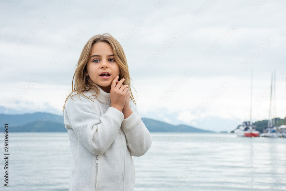 Standing child girl expresses diverse faces of surprise and curiosity. Standing child girl expresses diverse faces of surprise and curiosity.