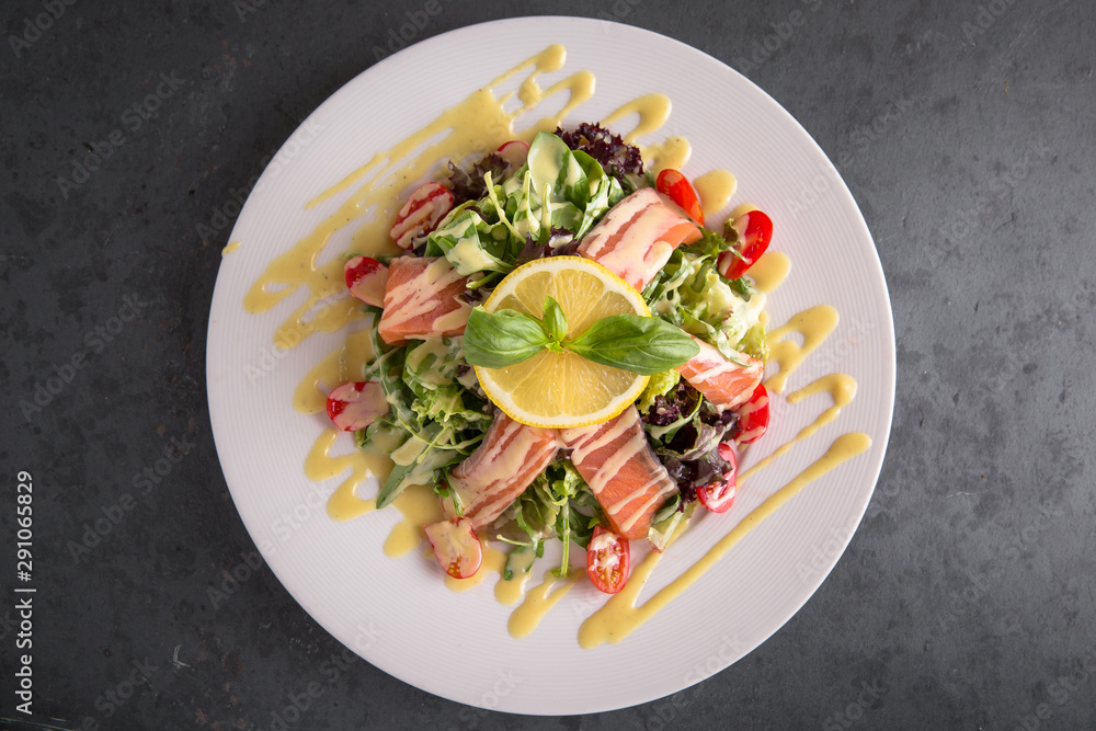 Healthy breakfast. Vitamin salad from arugula, fresh salmon, avocado, pumpkin seeds, cherry tomatoes and sauce Healthy breakfast. Vitamin salad from arugula, fresh salmon, avocado, pumpkin seeds, cherry tomatoes and sauce