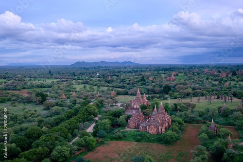 aerial view of sunset of Bagan Myanmar. Ancient pagoda in wide green landscape. Purple clouds skyline