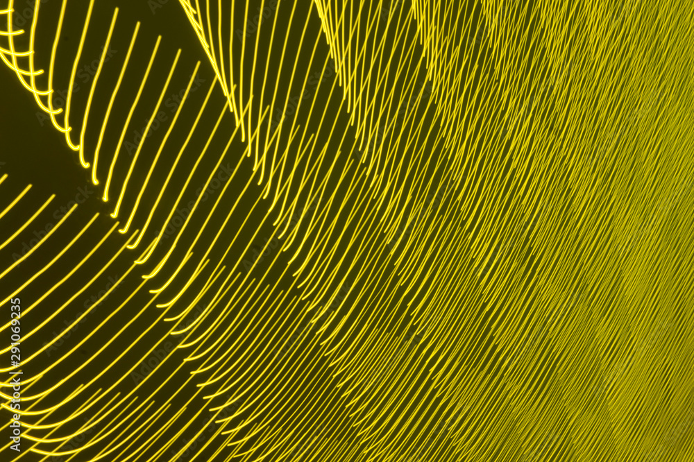 Obraz premium abstract long exposure blurred light lines black and yellow background. Geometric shapes