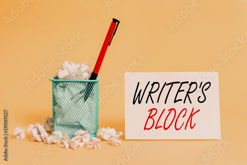 Text sign showing Writer S Block. Business photo showcasing Condition of being unable to think of what to write crumpled paper trash and stationary with note paper placed in the trash can photo