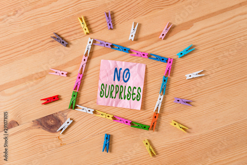 Text sign showing No Surprises. Business photo showcasing Presupposed Eventual Destined Traditional Set The Usual Colored clothespin papers empty reminder wooden floor background office photo