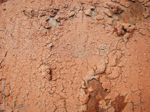 Iron with old skin-colored paint. Rust, swelling, cracks.