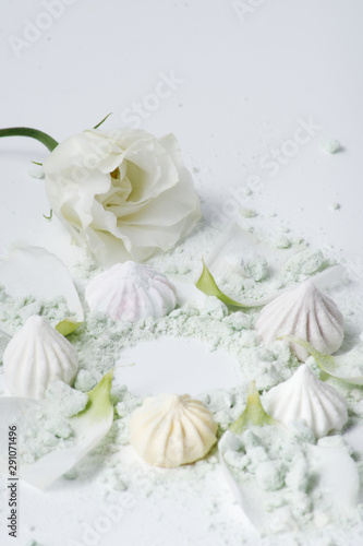 multicolored marshmallows and flowers on a white background