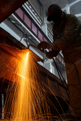 Industrial Worker at the factory welding closeup sparks long exposure