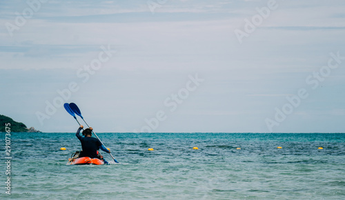 Men are paddling rubber boats and floating buoys in the sea.