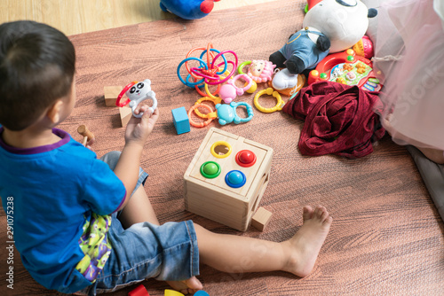 Asian child boy and girl enjoy playing wood toy together in room