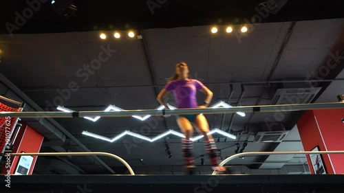 Wallpaper Mural The girl is skiing on a simulator with a large screen spotlight, simulates a ski run. She is dressed in shorts and a T-shirt and she has a beautiful figure. Torontodigital.ca