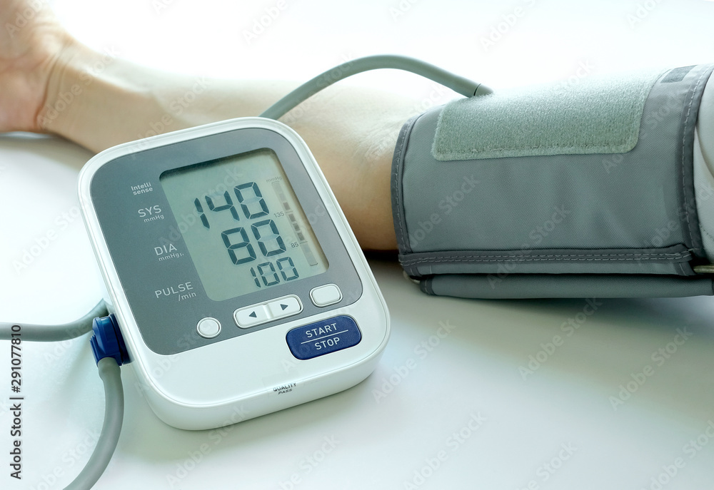 Man check blood pressure monitor and heart rate monitor with digital pressure gauge. Health care and Medical concept Man check blood pressure monitor and heart rate monitor with digital pressure gauge. Health care and Medical concept