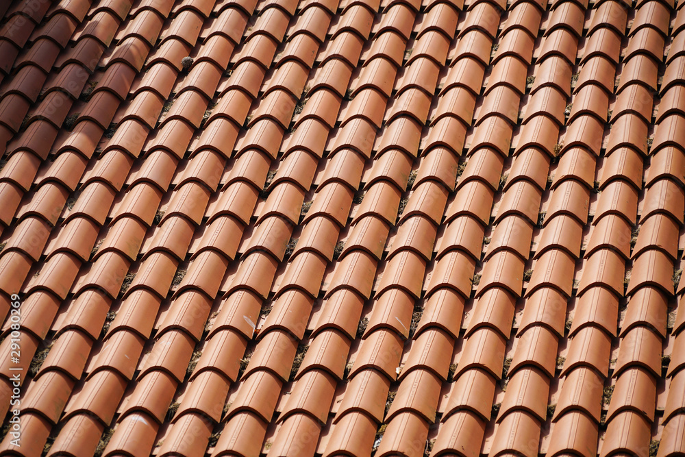 Red round roof tiles on houses, texture