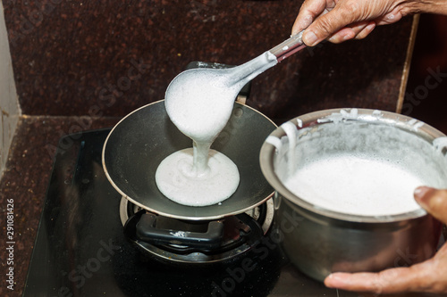 Preparation of Paalappam, Kerala's dish, in a appa chatti, nonstick pan