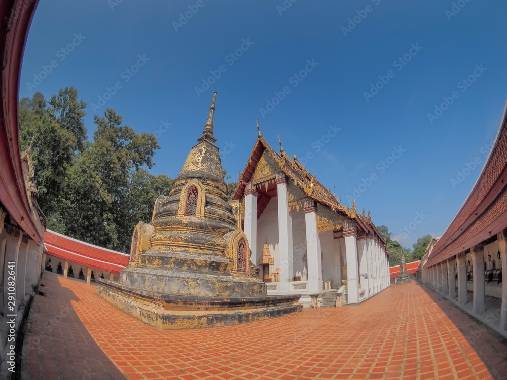 view of ancient Pagoda or Chedi wisth buddhist temple and blue sky background, Wat Khanon Nang Yai, Amphur Photharam, Ratchaburi, Thailand.