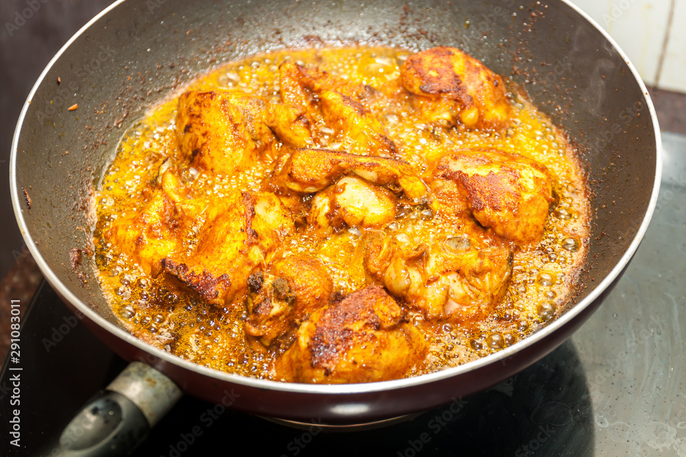 Marinated chicken frying in oil in a pan. Kerala style frying Marinated chicken frying in oil in a pan. Kerala style frying
