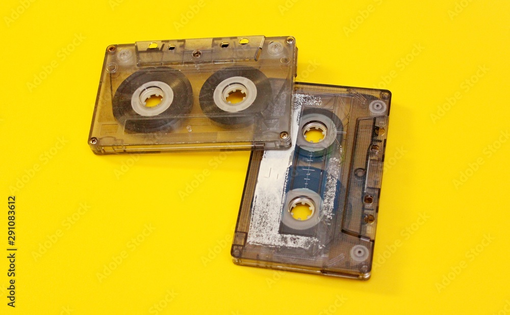 Old audio cassettes laid out on a yellow background Old audio cassettes laid out on a yellow background