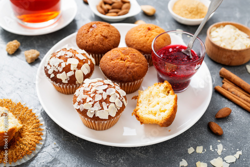 Homemade muffins with almond flakes and raspberry jam.