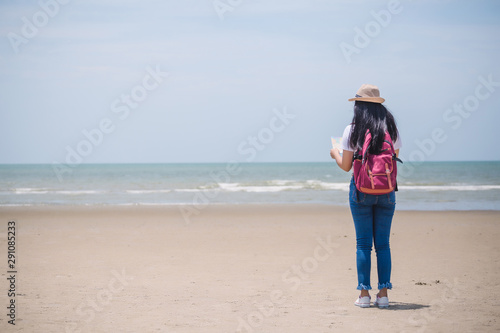Traveling people concept. Young happy asian gril at the beach