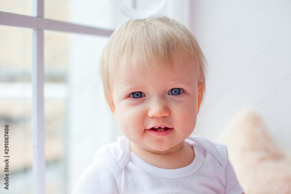 large portrait of a small child on the window