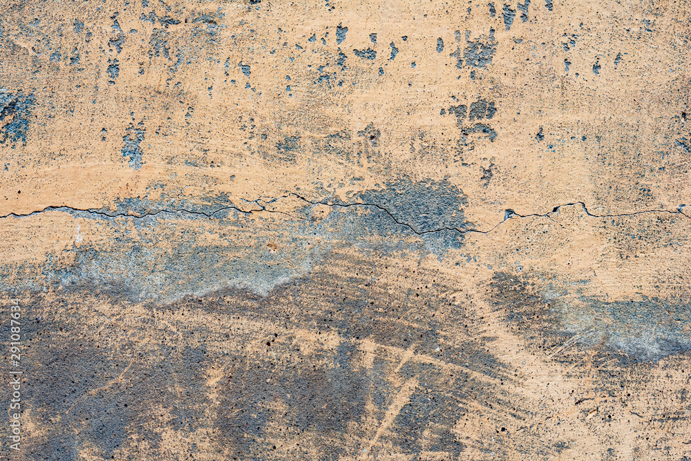 Texture of a concrete wall with cracks and scratches which can be used as a background Texture of a concrete wall with cracks and scratches which can be used as a background
