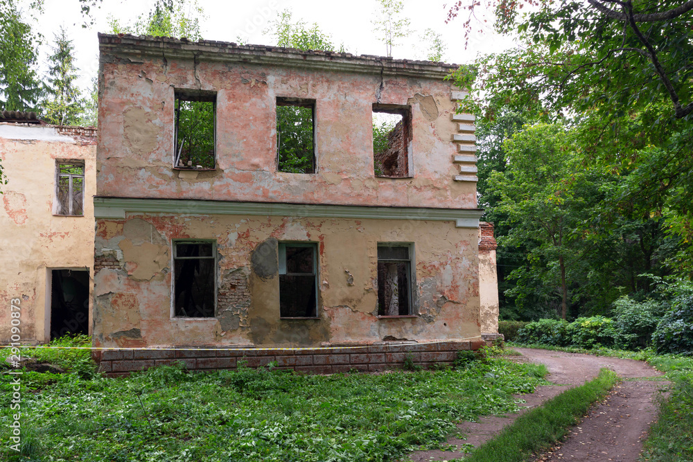 Abandoned, collapsed monument of architecture of the 19th century in a green, summer Park.