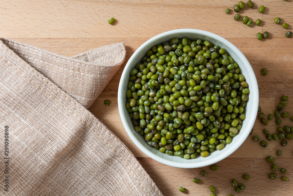 Top View of Green Mung Beans in a White Bowl on Wooden Table Top View of Green Mung Beans in a White Bowl on Wooden Table