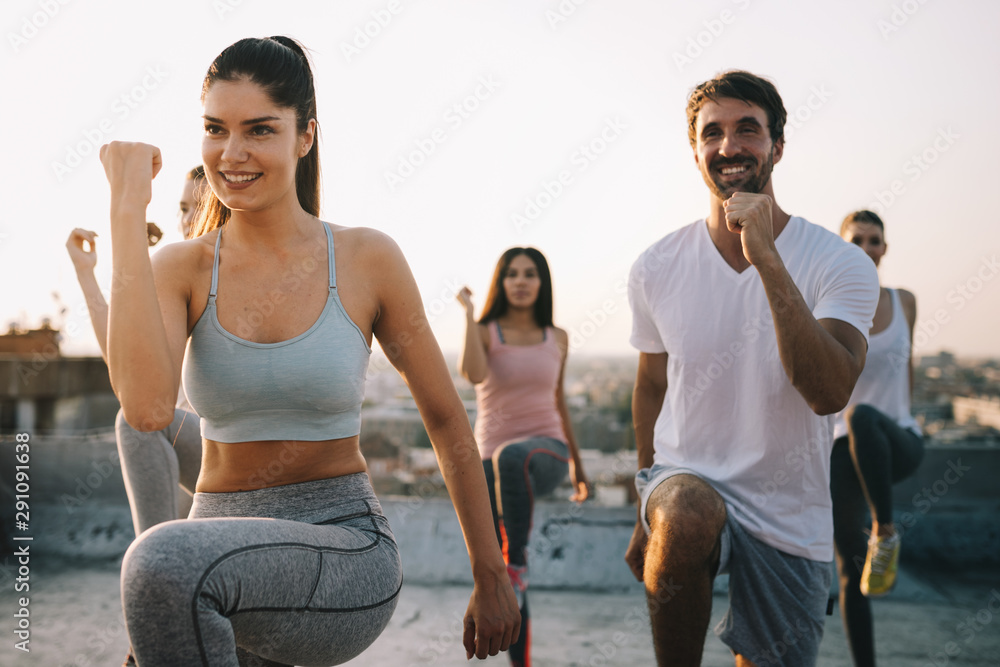 Fitness, sport, friendship and healthy lifestyle concept - group of happy sporty friends