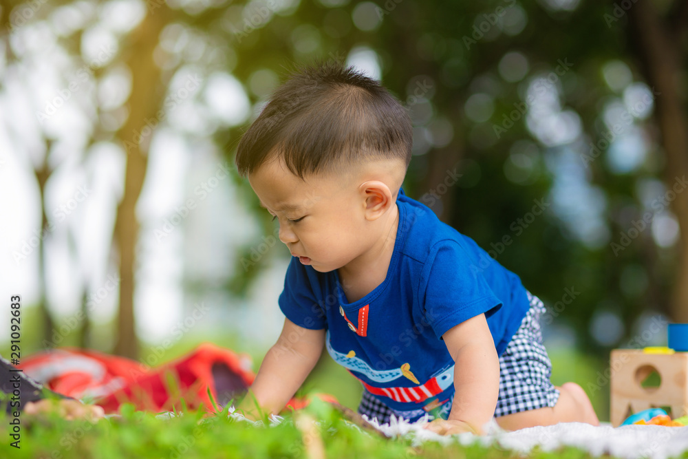Baby boy crawling on picnic mat green grass Baby boy crawling on picnic mat green grass