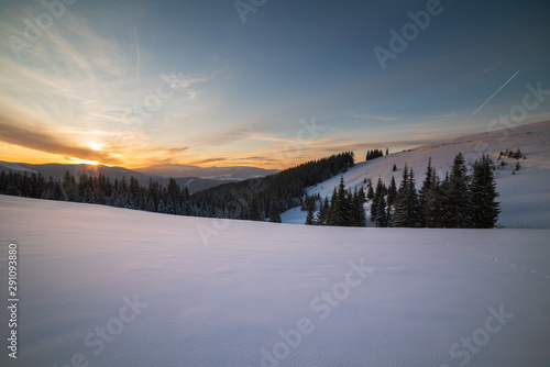 Winter landscapes of Ukrainian Carpathians with fog and snow mountain peaks
