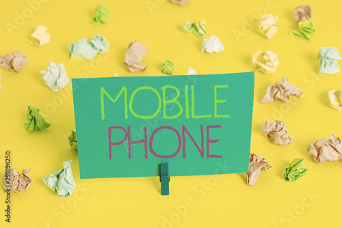 Writing note showing Mobile Phone. Business concept for A handheld device used to send receive calls and messages Colored crumpled paper empty reminder white floor clothespin © Artur