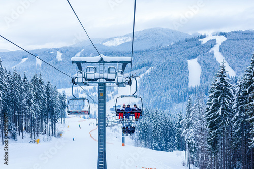Skiers on chairlift at ski resort