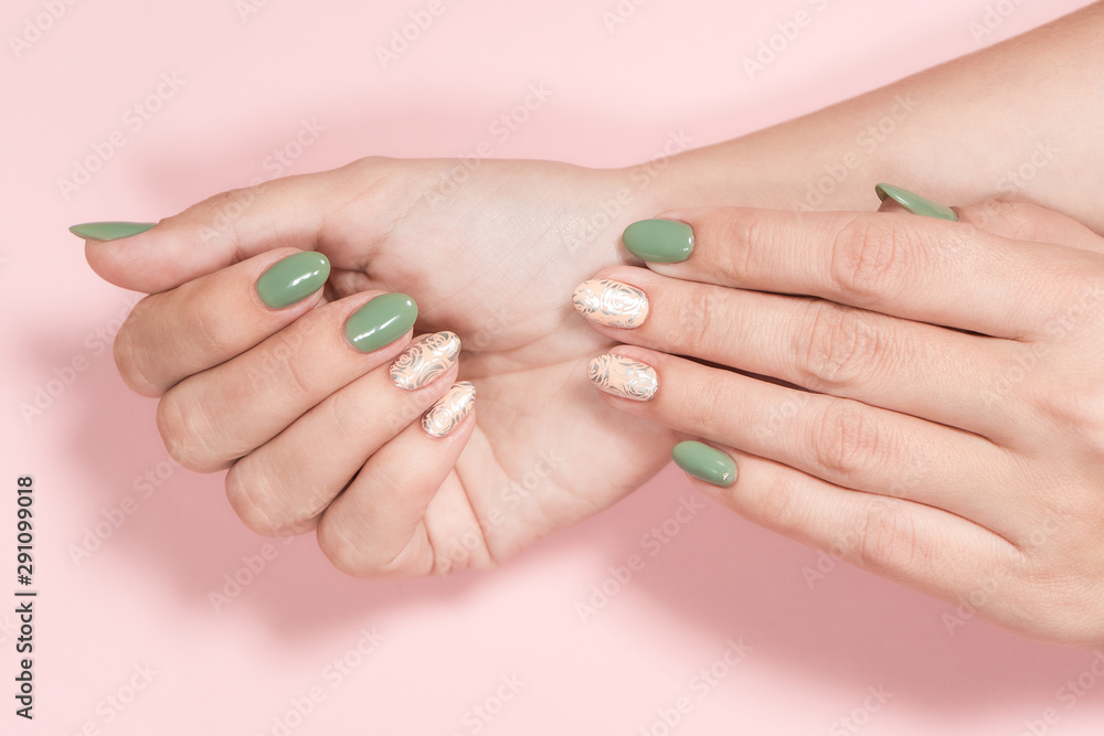 Closeup top view of 2 beautiful white female hands with trendy stylish two colours pastel manicure isolated on pink background. Top view flatlay photography. Closeup top view of 2 beautiful white female hands with trendy stylish two colours pastel manicure isolated on pink background. Top view flatlay photography.